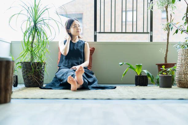istock A woman relaxing surrounded by foliage plants 1398114780