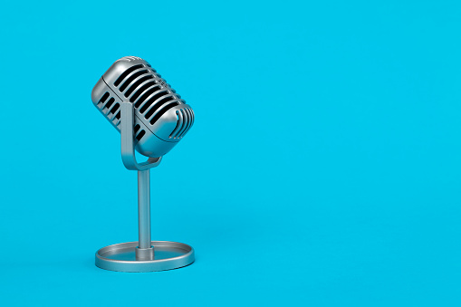 Retro microphone on blue background.