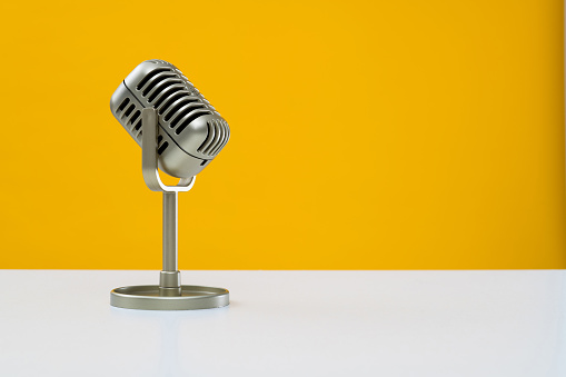Retro microphone on yellow background.