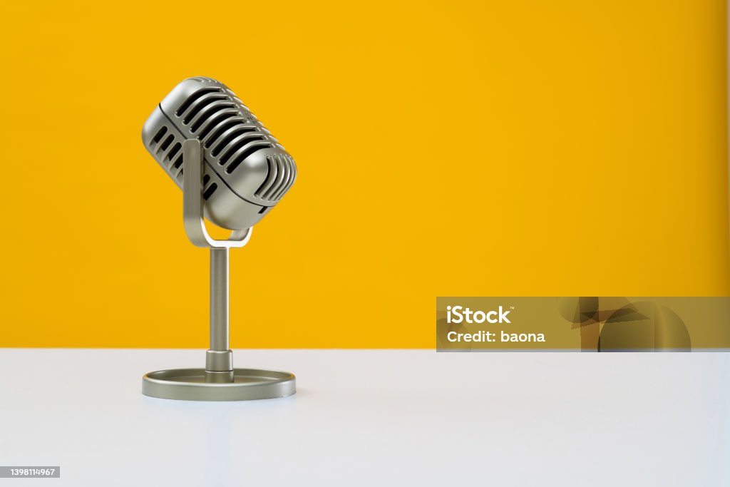 Retro microphone on yellow background Retro microphone on yellow background. Microphone Stock Photo