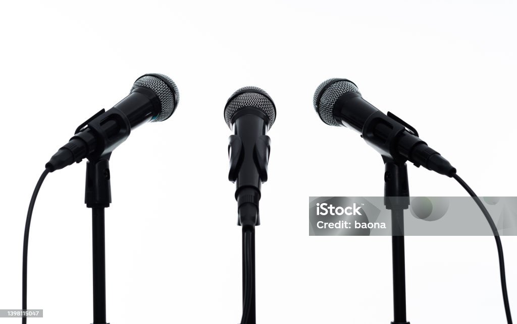 Three microphones on white background Three microphones on white background. Microphone Stock Photo