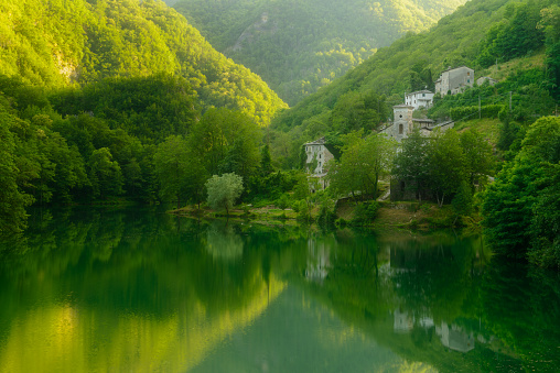 An ancient medieval village on the shores of Isola Santa lake surrounded by the nature of the Apuan Alps