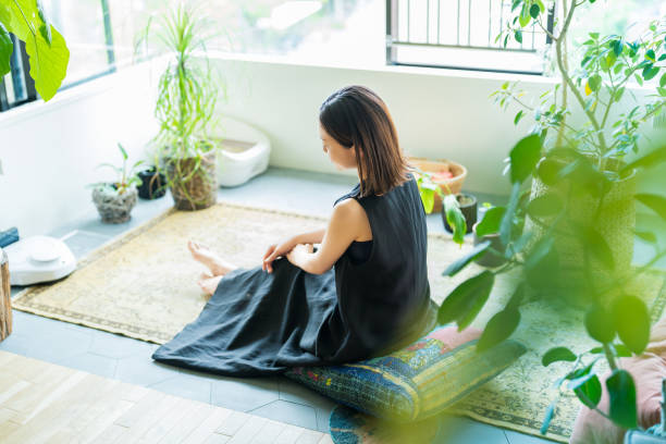 istock A woman relaxing surrounded by foliage plants 1398116060