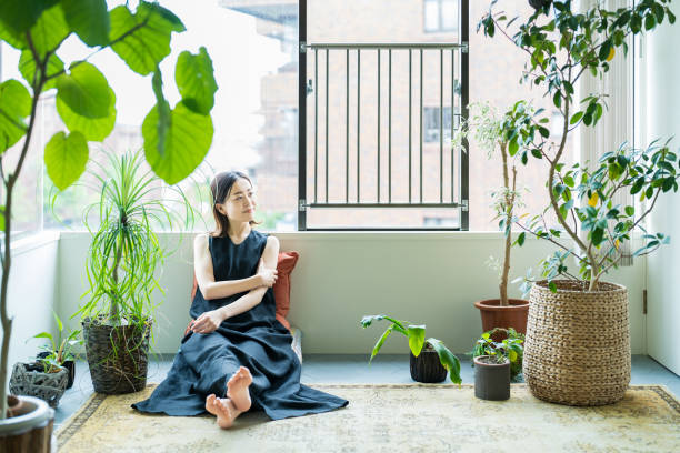 istock A woman relaxing surrounded by foliage plants 1398116153