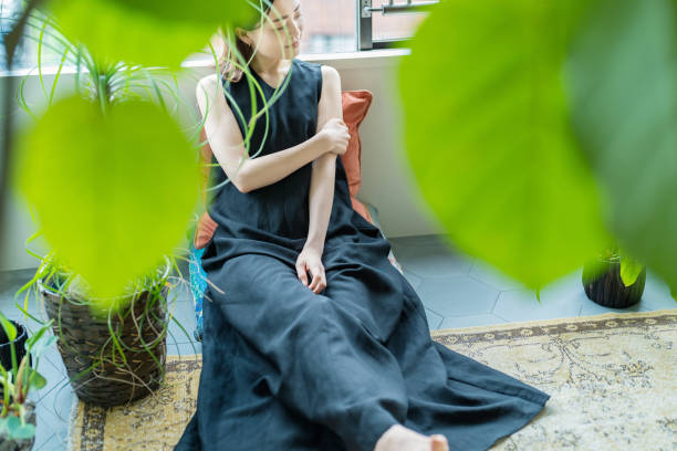 istock A woman relaxing surrounded by foliage plants 1398116443