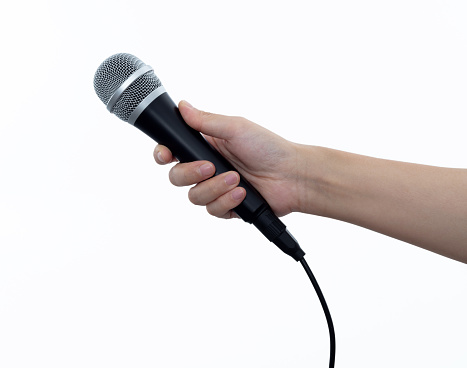 Hand holding a microphone on white background.