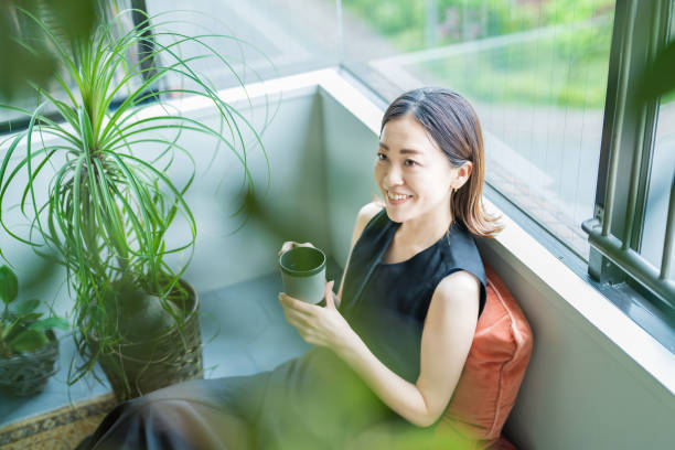 istock A woman relaxing surrounded by foliage plants 1398117565