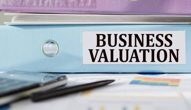 istock BUSINESS VALUATION text written on folder with documents and calculator. 1398119403