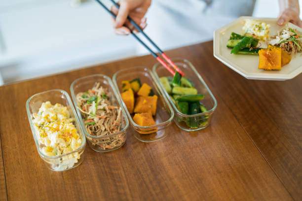 istock A woman who puts prepared side dishes on a plate 1398119614