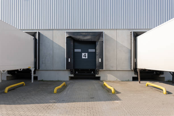istock trucks and trailers at loading ramps of a warehouse 1398119644