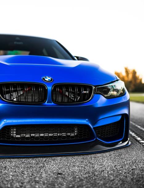 Seattle, WA, USAJuly 1, 2021Blue BMW M3 with gold wheels parked on a private street for a photo shoot.