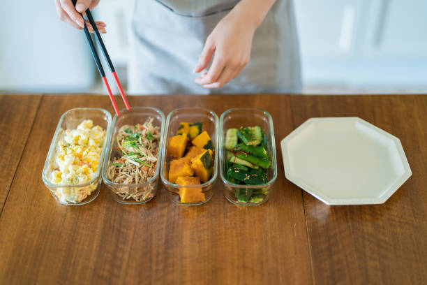 istock A woman who puts prepared side dishes on a plate 1398119705