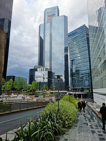 The Tour Total building now serves as headquarters for TotalEnergies. The  office building in La Défense with a height of 187 m was planned by WZMH Architects, Roger Saubot and realized between 182 and 1985. The image was captured during springtime.