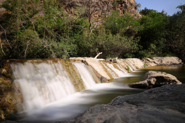 Picturesque waterfall in summer mountain gorge
