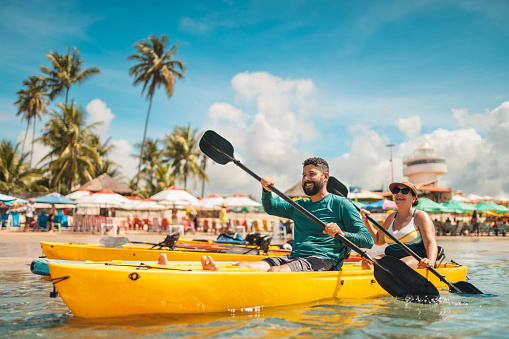 Tourists paddling kayak at Porto de Galinhas beach in Pernambuco, Brazil