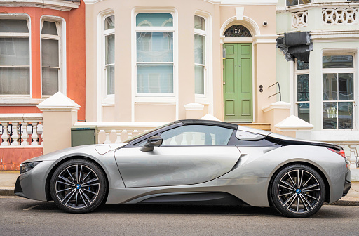 London, UK - A side view of a BMW i8 sports car, park on a residential street in Notting Hill, London.