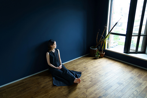 A woman relaxing in a room with a calm atmosphere
