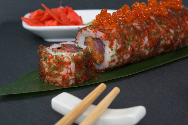 istock on the table, on a bamboo leaf, rolls with fish and caviar, ginger and chopsticks, a close-up of everything 1398123504
