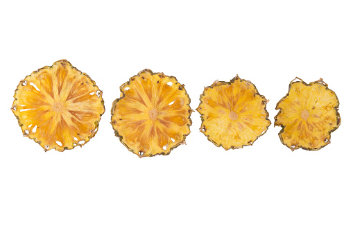 dried pineapple fruit cut into rings, close-up, on a white background