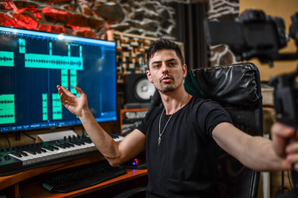 istock Handsome Producer Showing Working Desk While Recording Video Vlog 1398124986