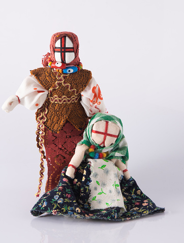 Lyalka motanka handmade. Ukrainian national doll amulet, silt patches and threads are made without a needle. Symbol of Ukraine. Motanka dolls on a white background. Old toy.