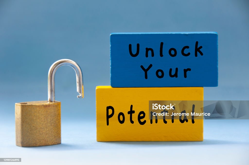 Unlock your potential text on wooden blocks with pad lock on light blue background. Unlock your potential text on wooden blocks with pad lock on light blue background. Motivational concept Aspirations Stock Photo
