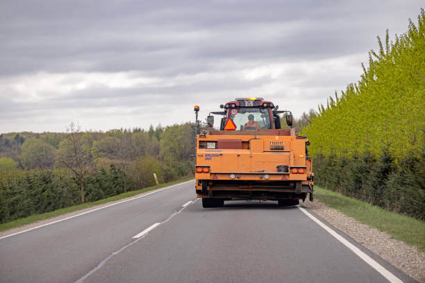 a big machine moving through a road