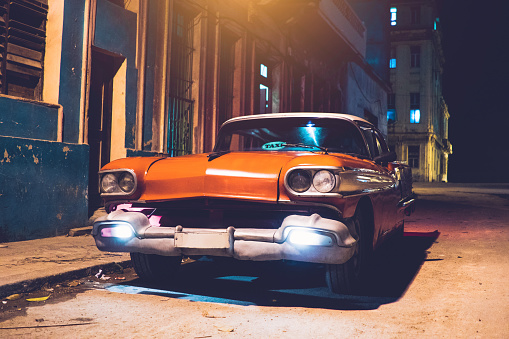 American car used as a taxi on street at night, Havana, Cuba