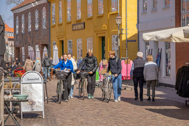 Group of people walking down the pedestrian street in a old town Group of young people walking down the pedestrian street in Ribe, which is one of the oldest town in Denmark and is situated to the south west on the peninsular Jutland ribe town photos stock pictures, royalty-free photos & images