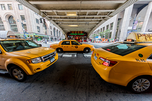 NEW YORK CITY, USA - May 28, 2016: Yellow taxi cabs in New York City wait outside Grand Central Terminal for customers.