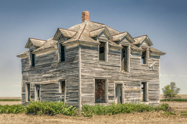abandoned old house in rural Nebraska in the middle of a field