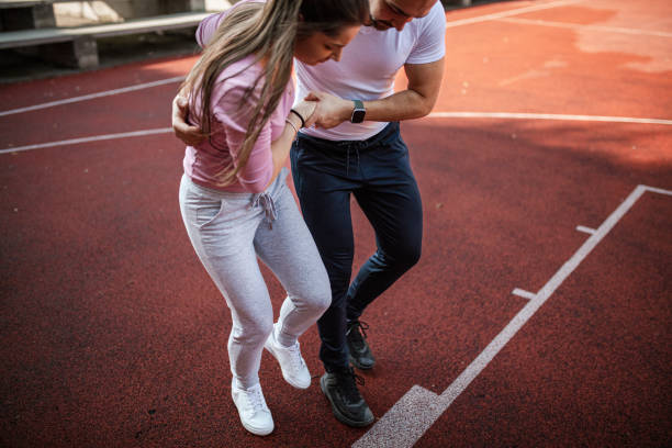 istock Boyfriend helping his girlfriend with sprained ankle 1398132945