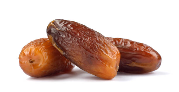 istock Three delicious dried dates are isolated on a white background. Full clipping path. 1398134563
