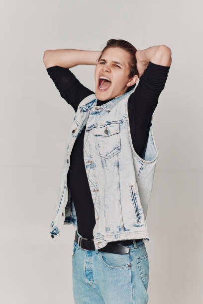 istock young man with mouth opened in shout on gray background 1398135350