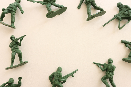 image of toy soldiers over pastel background