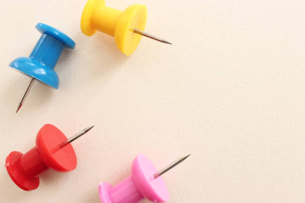 istock Close up image of push pins over pastel background 1398135601