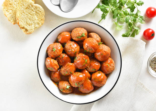 Meatballs with tomato sauce in bowl Meatballs with tomato sauce in bowl over white background. Top view, flat lay chicken balls stock pictures, royalty-free photos & images