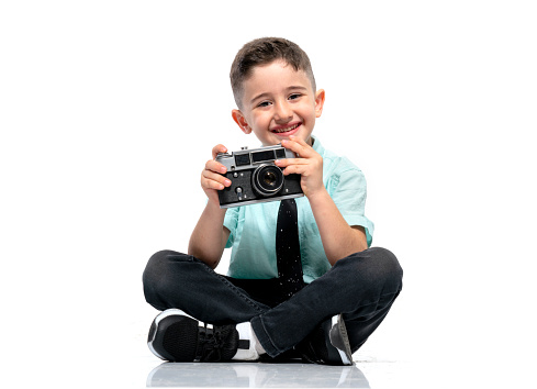Cute young boy looking at the camera photographer