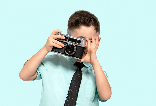 Cute young boy looking at the camera photographer