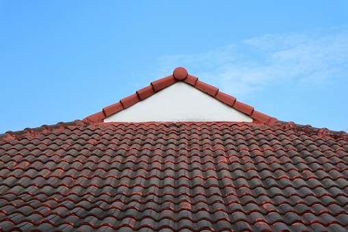 Old tile roof with blue sky. Industrial and object concept.