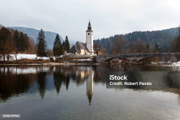 Lake Bohinj With Its Church And Bridge Stock Photo - Download Image Now - Absence, Architecture, Baptist