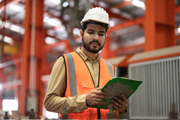 istock Portrait engineer, mechanic checking with machine at factory 1398140385