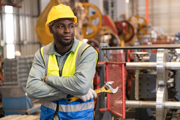 istock Portrait engineer, mechanic with machine at factory 1398140948
