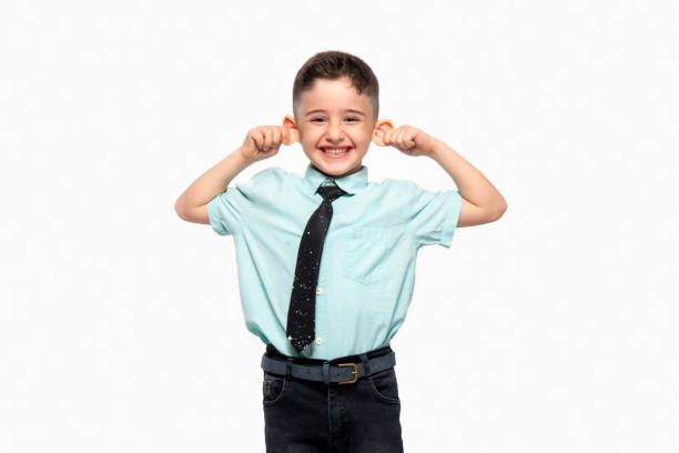 istock Cute little boy holding his ear laughs.Otoplasty 1398140997