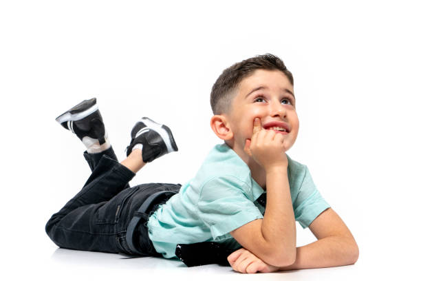 Cute little boy dreaming and thinking on a white background