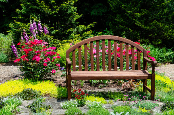 istock Pretty Garden Path with Flowers and Garden Bench 1398141860
