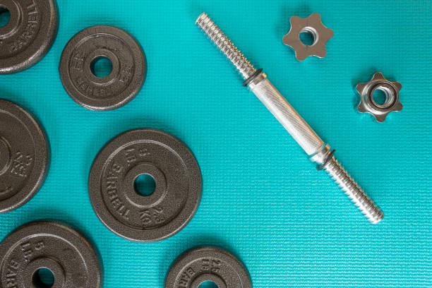 istock disassemble weight bars barbells on a turquoise blue mat 1398141864