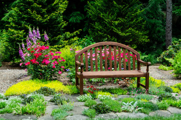 istock Pretty Garden Path with Flowers and Garden Bench 1398141939