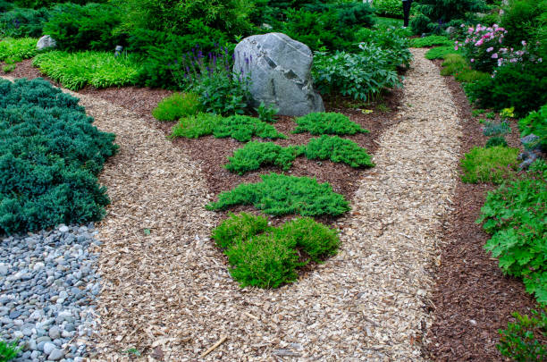istock Pretty Garden Path with Flowers and Garden Bench 1398142550