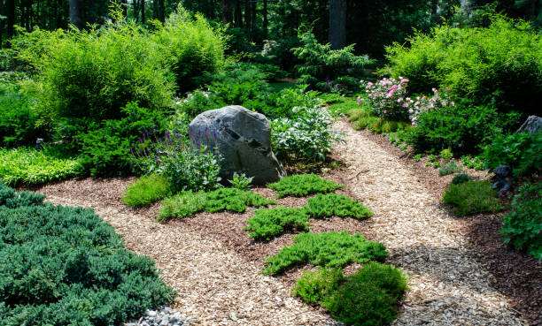 istock Pretty Garden Path with Flowers and Garden Bench 1398142675
